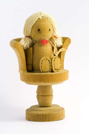 Old toy is a wood doll sit in a chairの写真素材