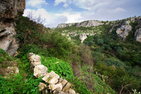 Typical rural landscape in the sicilian hinterland with typical rural stone wall. Sicily, Syracuse, Italy.の写真素材