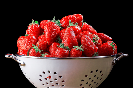 Strawberry in white Bowl on dark background. Isolated on black background.の写真素材