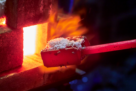 Hot item is inserted into the blacksmith's forge from which the tongues of flame. Concept: blacksmithing, forgeの写真素材
