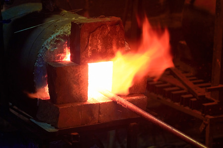 Blacksmith furnace, forge from which the tongues of flame.with metal bar. Homemade furnace with gas flame.の写真素材