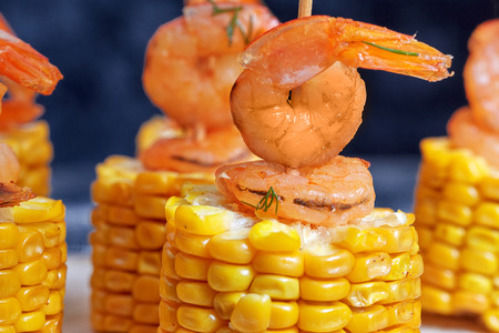 Grilled spicy corn on the cob with shrimp served skewerの写真素材