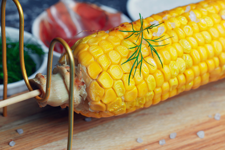 Grilled corn cob with bacon, salt and herbs. Grilled corn cob with bacon, salt and herbs.  Concept of feed corn in the restaurantの写真素材