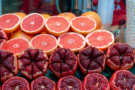 Cut red grenades with red grapefruitsの写真素材