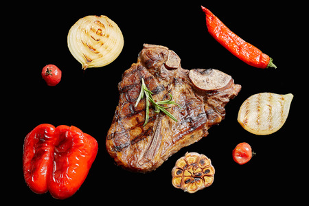 T-Bon steak grilled with vegetables. Fried meat on the fire, barbecue. Black isolateの写真素材