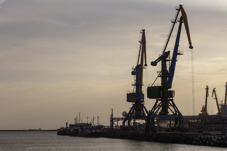 silhouette of port cranes at sunsetの写真素材