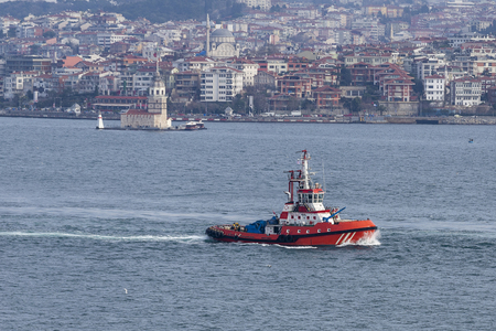 Red fire tug boat equipped with saftey equipmentの写真素材