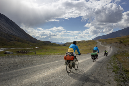 Cyclists ride on the road in the mountains. Concept: travel, mountain Bikingの写真素材