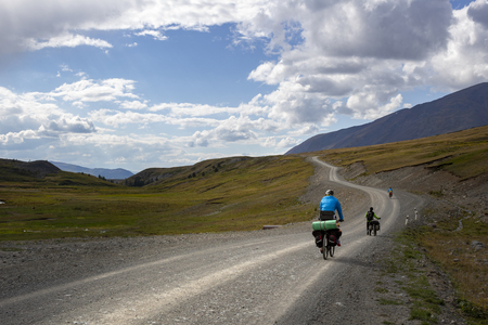 Cyclists ride on the road in the mountains. Concept: travel, mountain Bikingの写真素材