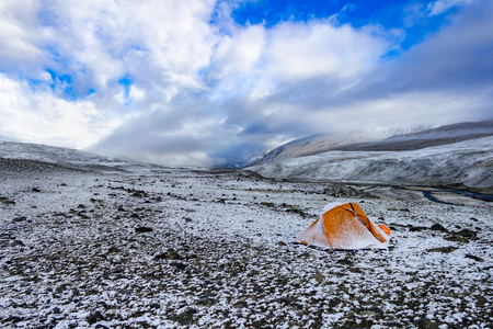 Snow-covered tent in the mountainsの写真素材