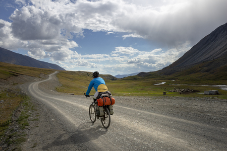 Cyclists ride on the road in the mountains. Concept: travel, mountain Bikingの写真素材