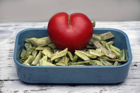 Heart shaped tomato jn beens. I love healthy food.の写真素材