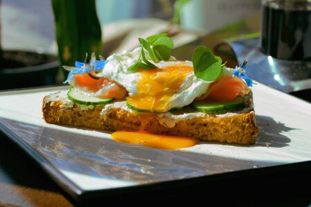 Smorrebrod, Danish Open Sandwich with Smoked Salmon, square with poached eggの写真素材