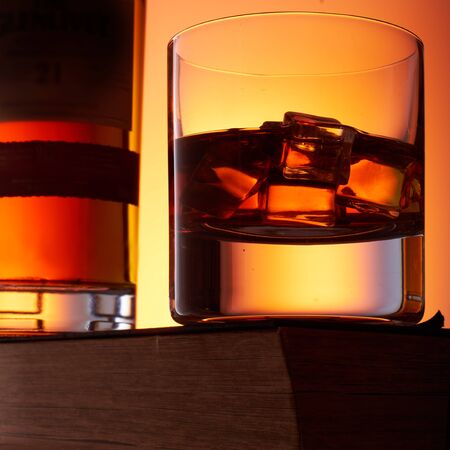 Old fashion whiskey on the rocks with a bottleの写真素材