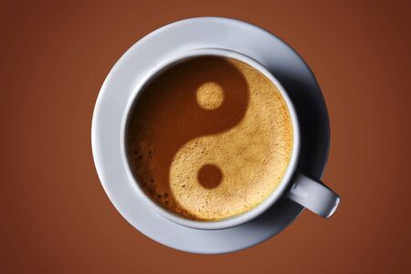 Cup of coffee on black background. Picture of the yin-yang in the coffee crema. top view. coffee in the form of Yin Yang top viewの写真素材