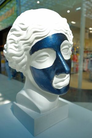White bust of young woman in the Mall. dark face maskの写真素材