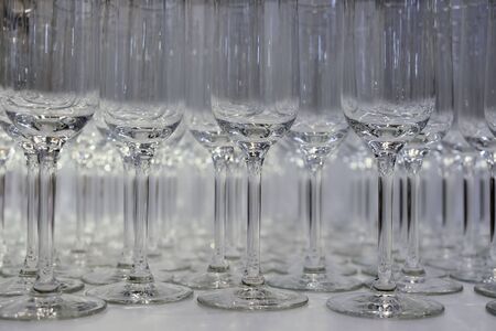 Many wine glasses on the table. rows of empty wine glassesの写真素材
