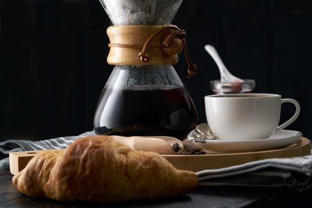 Pour over coffee brewing method. Making pour over coffee with hot water being poured from a kettle....