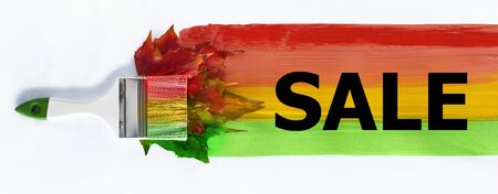 paint brush in the colors of autumn. brush across the page draws a strip of autumn colors. Autumn maple leaves. concept: autumn creative, sale, Black Friday. copy space. isolate of white.の写真素材