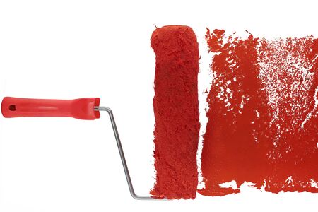 red paint roller leaving a smear of red paint on a white sheet. white backgroundの写真素材