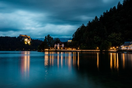 Beautiful mountain lake Bled . Night scenery at Bled lake in Slovenia. Ðusk scene on lake, illuminated castle on hill.の写真素材