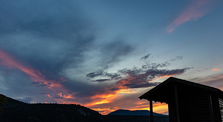 Orange and yellow sunset with mountains silhouettes. Gradient vivid nature background.の写真素材