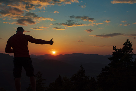 Orange and yellow sunset with mountains silhouettes. Gradient vivid nature background.の写真素材