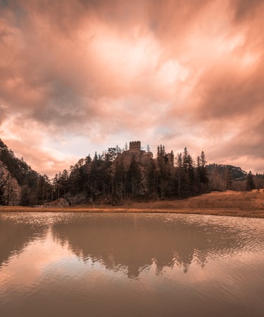 Beautiful mountain lake with a castle on a hill during sunset in spring in austriaの写真素材