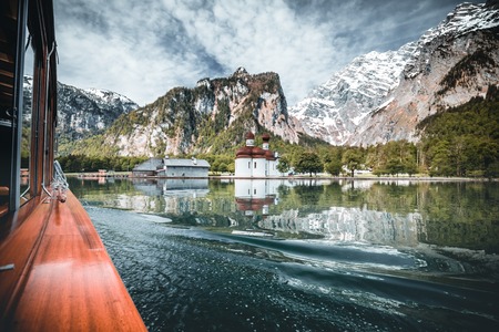 boat drive on the Königssee in Berchtesgaden in Germany Bavaria. a very beautiful lake with reflecting mountains in the water during Springの写真素材