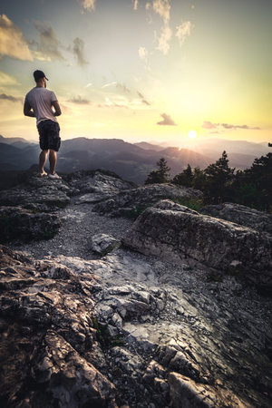 Man on top of mountain. Conceptual scene on Hohe Wand in Austria during Sunset