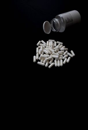 white pills on black background. medical pharmacy supplementsの写真素材