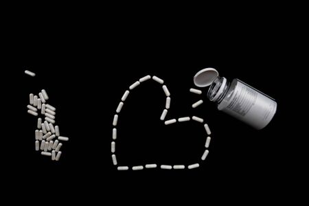 white pills on black background. medical pharmacy supplementsの写真素材