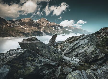 alpine landscape with peaks covered by snow and clouds in the alps in austriaの写真素材