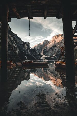 Lake Braies also known as Pragser Wildsee or Lago di Braies in Dolomites Mountains, Sudtirol, Italy. Romantic place with typical wooden boats on the alpine lake.の写真素材