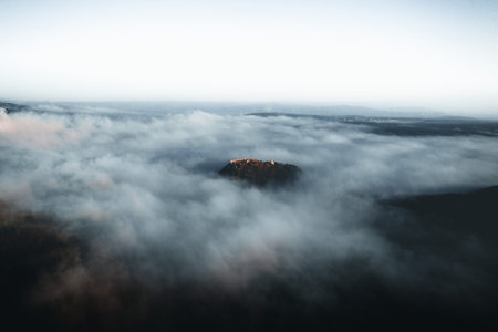 Amazing aerial view of blue foggy river and colorful forest on sunrise. Autumn landscape. Drone shot...
