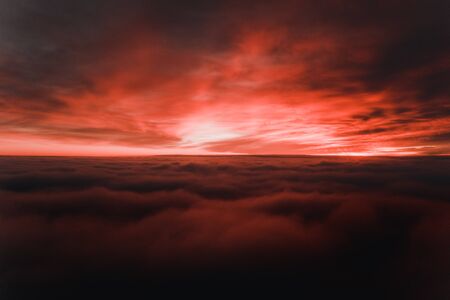 Beautiful sunrise cloudy sky from aerial view. Airplane view above clouds - Backgroundの写真素材