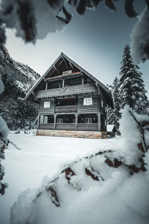 wooden house in winter forest in austria