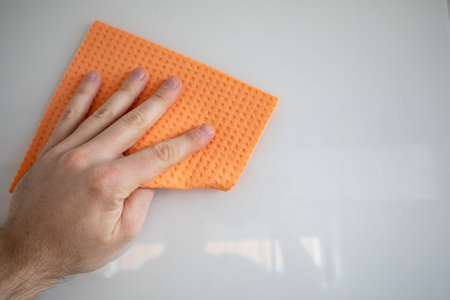 hand cleaning with orange sponge isolated on white background. Spring Cleaning Theme