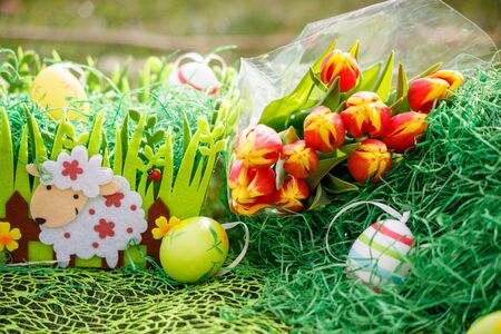 Colorful Easter eggs decorated with flowers in the grass background with spaceの写真素材