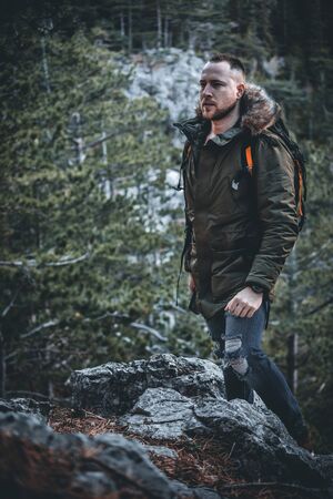 man hiker with backpack enjoying the nature in the forestの写真素材