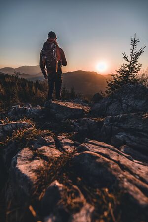 Man standing on Mountain Peak enjoying the Sunset in Springの写真素材