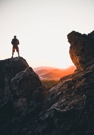 Man on top of mountain watching the sunset in the Alps of Austriaの写真素材