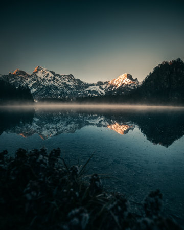 Lake Almsee with Mountain Reflection during Sunrise during Spring in Austriaの写真素材