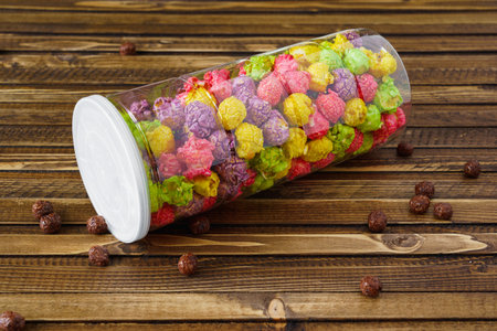 jar of colored popcorn on a woody vintage background. High quality photoの写真素材
