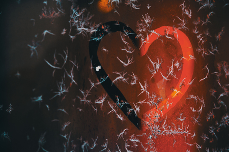 Hand-drawn hearts on a frosted glassの写真素材