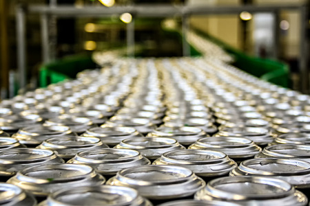Beverage aluminum cans on conveyor line at factoryの写真素材