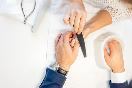 Man gets his manicure done, hands closeupの写真素材