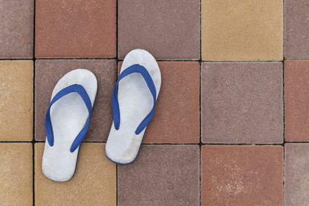 Old sandals on colorful brick floors.の写真素材
