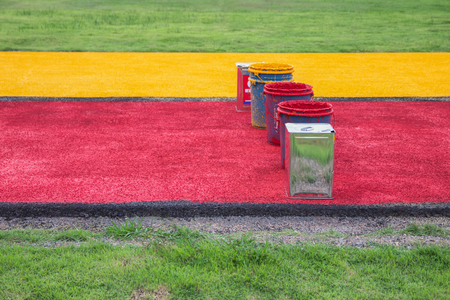 Red and yellow paint tanks used on roads in Thailand.の写真素材