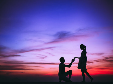 Silhouette of Happy Young Couple Hugging Outside at Sunset,proposing